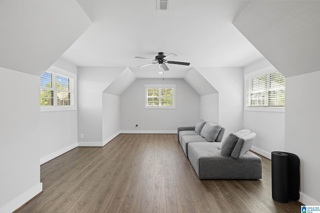 living area with wood-type flooring, ceiling fan, and vaulted ceiling