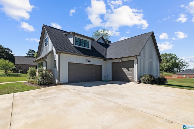 view of front facade with a front yard and a garage