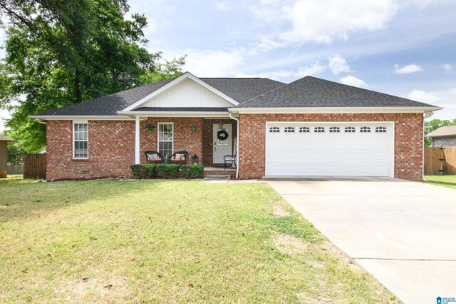 ranch-style home with a garage and a front lawn