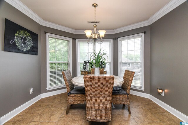 tiled dining area with a healthy amount of sunlight, an inviting chandelier, and ornamental molding