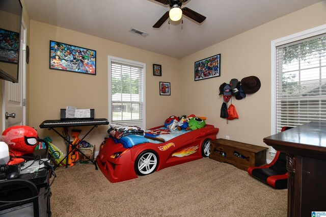 bedroom with ceiling fan and carpet floors