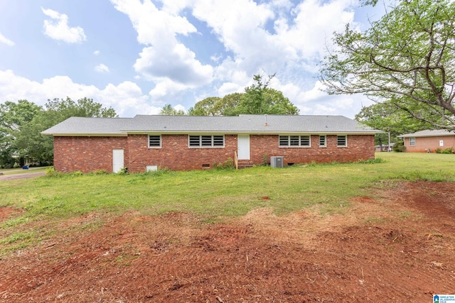 rear view of house with a yard and central AC unit