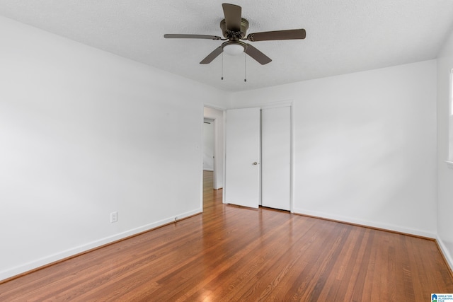 unfurnished bedroom with ceiling fan and hardwood / wood-style flooring