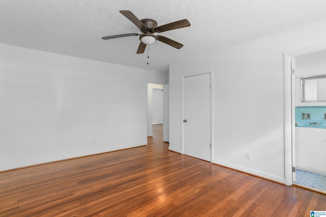 unfurnished bedroom with hardwood / wood-style floors, ceiling fan, and a textured ceiling