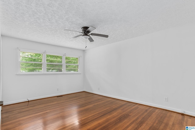 spare room featuring hardwood / wood-style flooring, ceiling fan, and a textured ceiling