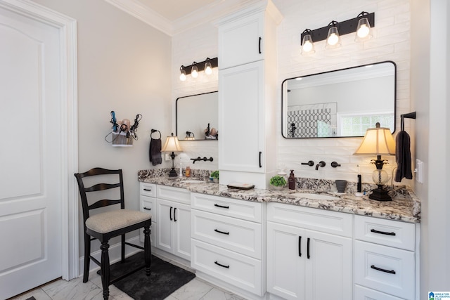 bathroom with crown molding and vanity