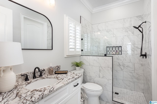 bathroom featuring crown molding, vanity, toilet, and a tile shower