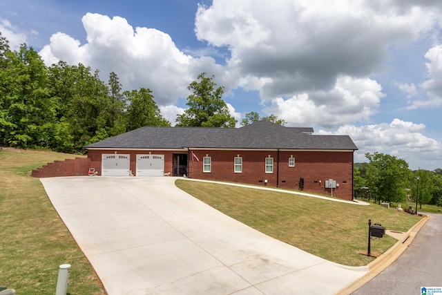 view of front of property with a front yard and a garage