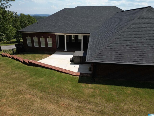 rear view of property with a yard and a patio