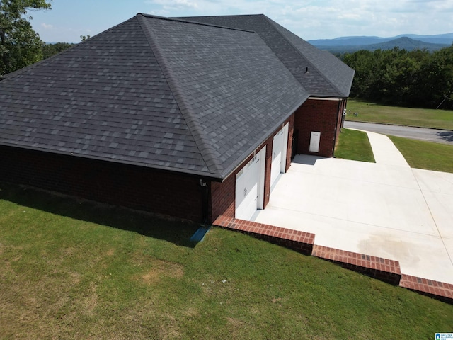 view of home's exterior featuring a mountain view and a yard