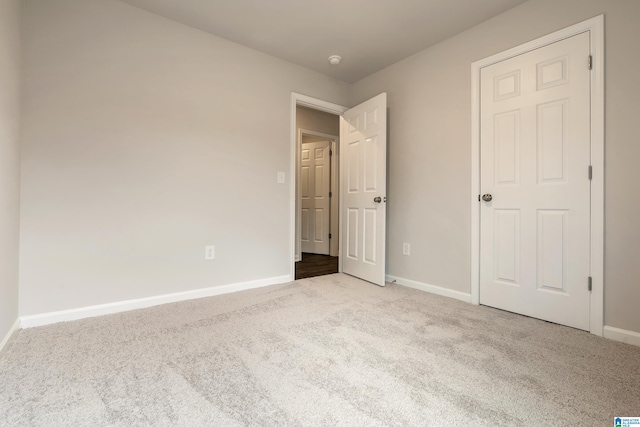 unfurnished bedroom featuring light carpet