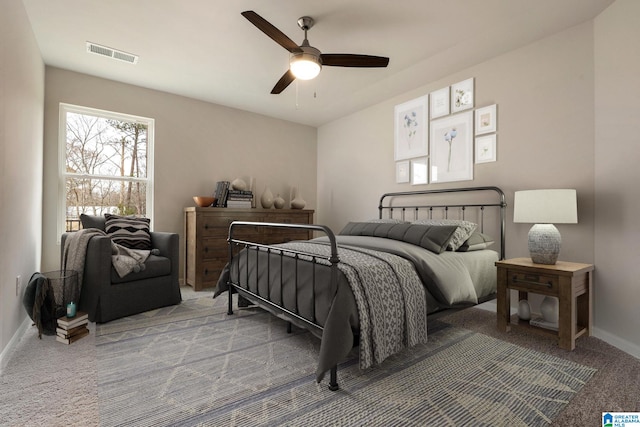 bedroom featuring ceiling fan and carpet