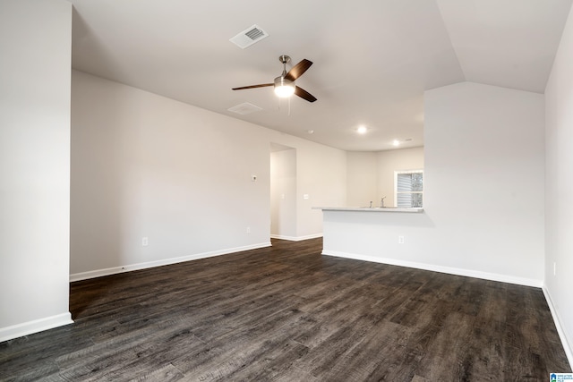 unfurnished living room with dark hardwood / wood-style floors, ceiling fan, and vaulted ceiling