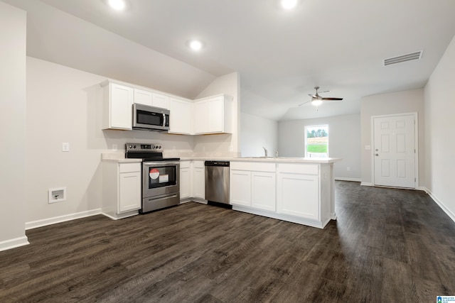 kitchen featuring kitchen peninsula, appliances with stainless steel finishes, white cabinets, and lofted ceiling