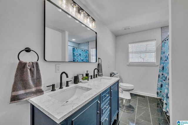 bathroom with vanity, toilet, and walk in shower