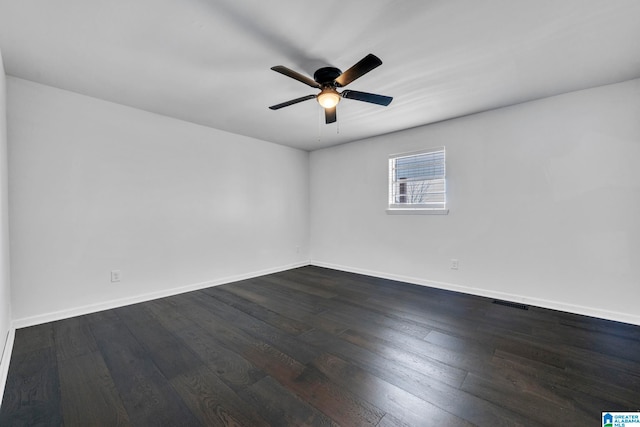 empty room featuring dark wood-type flooring and ceiling fan