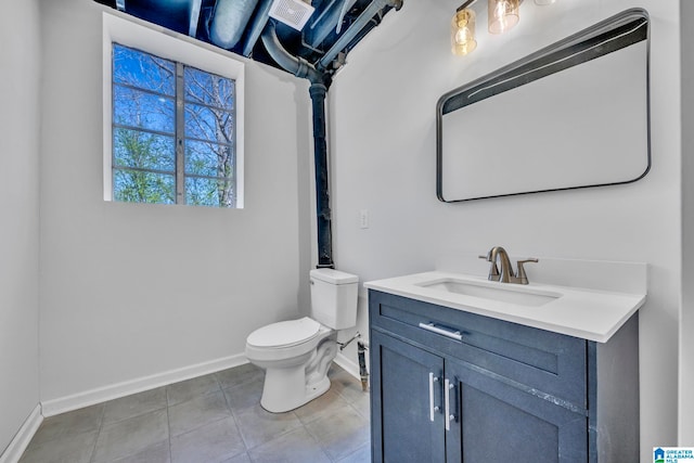 bathroom with vanity, toilet, and tile patterned floors