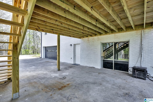 view of patio / terrace with a garage and stairs