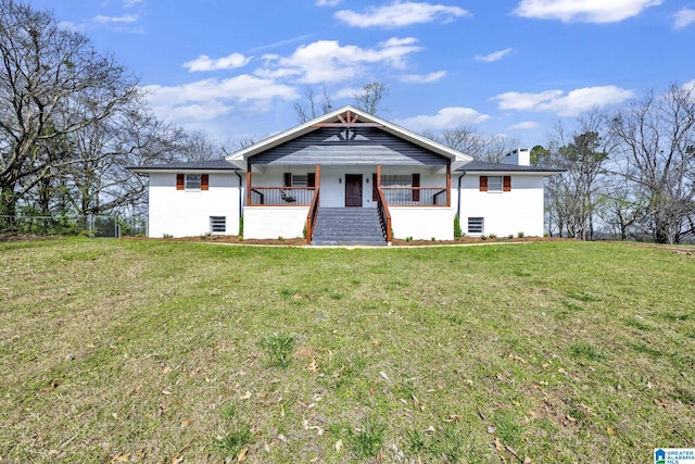 view of front facade featuring covered porch, a chimney, and a front yard