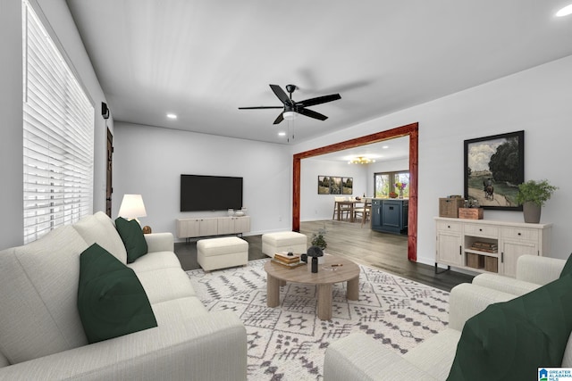 living room with ceiling fan, plenty of natural light, and light hardwood / wood-style flooring