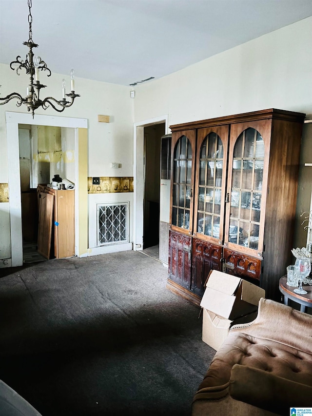 carpeted living room featuring a chandelier