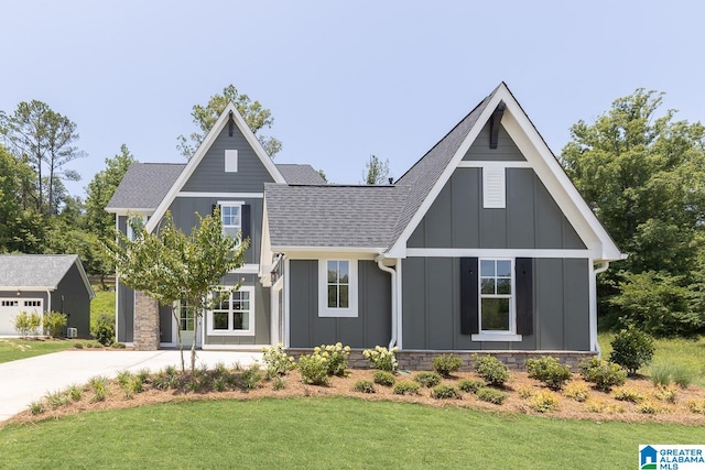 view of front of home with a garage and a front lawn