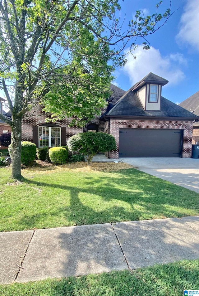 view of front facade with a front yard and a garage