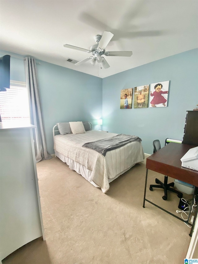 bedroom featuring light carpet and ceiling fan