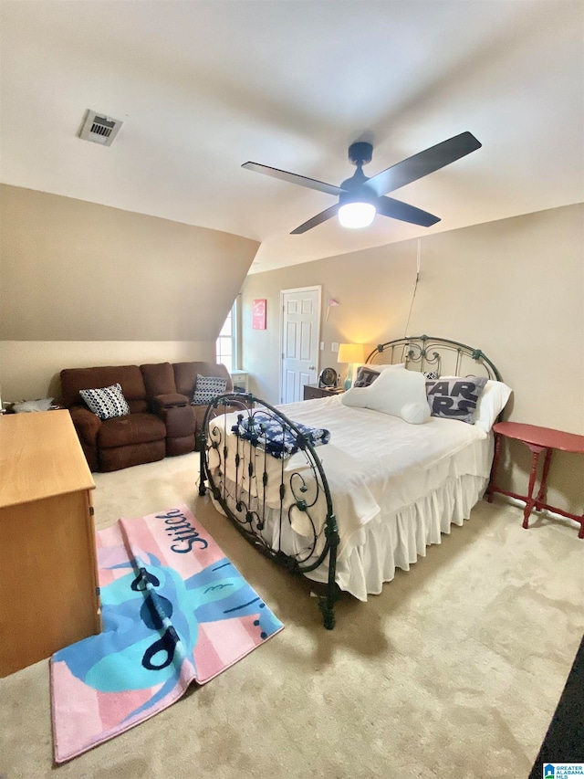 carpeted bedroom with ceiling fan and lofted ceiling