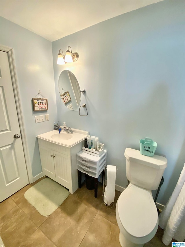 bathroom featuring tile patterned floors, vanity, and toilet