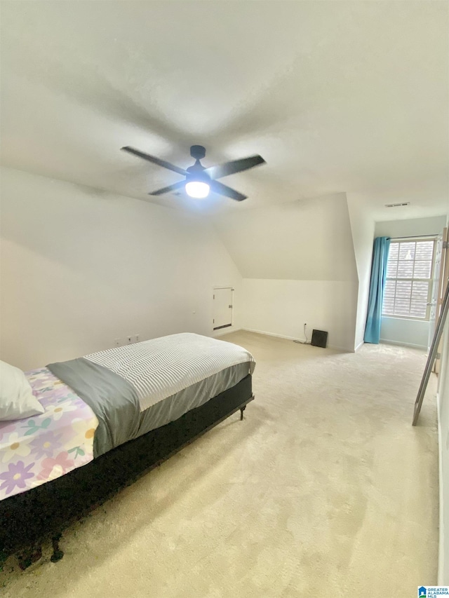 carpeted bedroom featuring ceiling fan and lofted ceiling