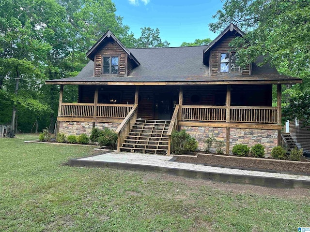 log cabin featuring covered porch and a front yard