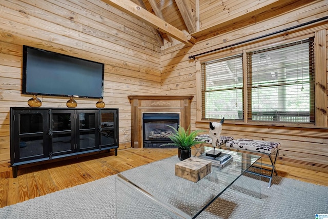 living room with wooden ceiling, lofted ceiling with beams, light wood-type flooring, and wooden walls