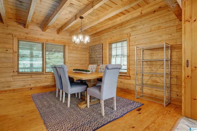 dining space with wooden ceiling, light hardwood / wood-style flooring, a chandelier, and beam ceiling