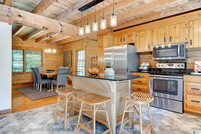 kitchen with beam ceiling, stainless steel appliances, an inviting chandelier, and decorative light fixtures