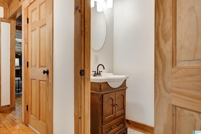 bathroom with wood-type flooring and vanity