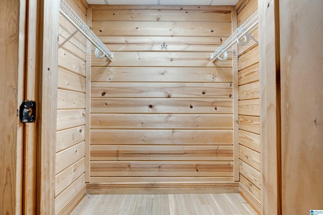 walk in closet with hardwood / wood-style floors