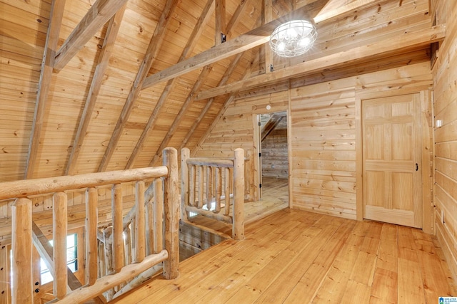 additional living space featuring wood ceiling, vaulted ceiling with beams, light wood-type flooring, and wooden walls