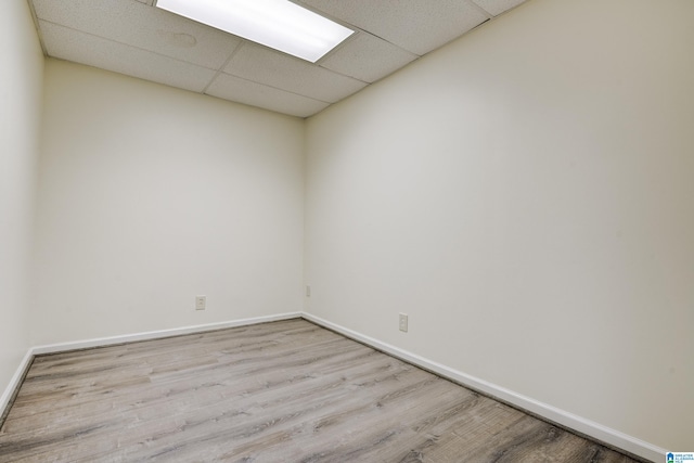 spare room with wood-type flooring and a paneled ceiling