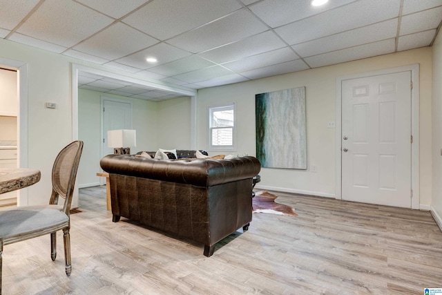 living room featuring hardwood / wood-style floors and a paneled ceiling