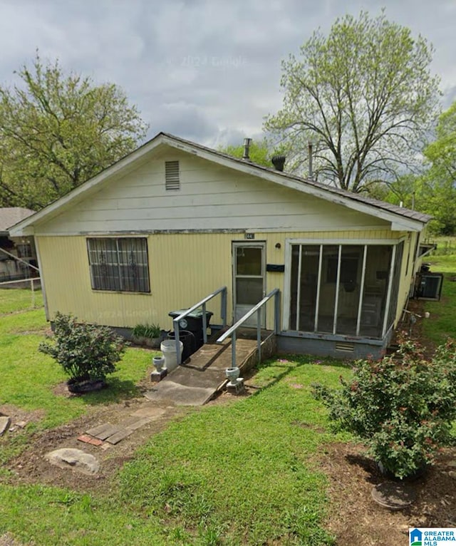 back of house with a lawn