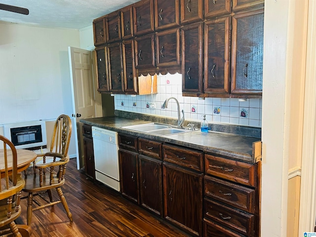 kitchen featuring dark wood-type flooring, dark brown cabinetry, sink, tasteful backsplash, and white dishwasher