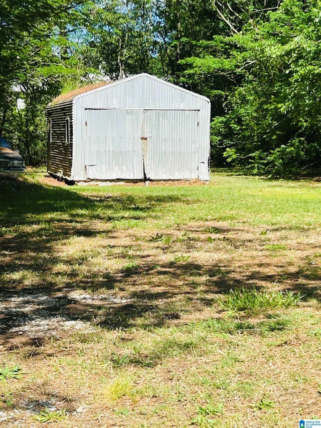 view of outdoor structure with a lawn