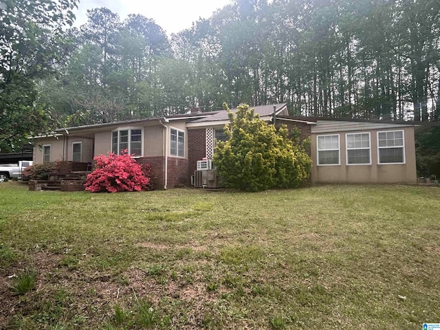 rear view of house with a lawn