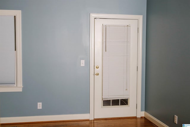 entryway with hardwood / wood-style flooring