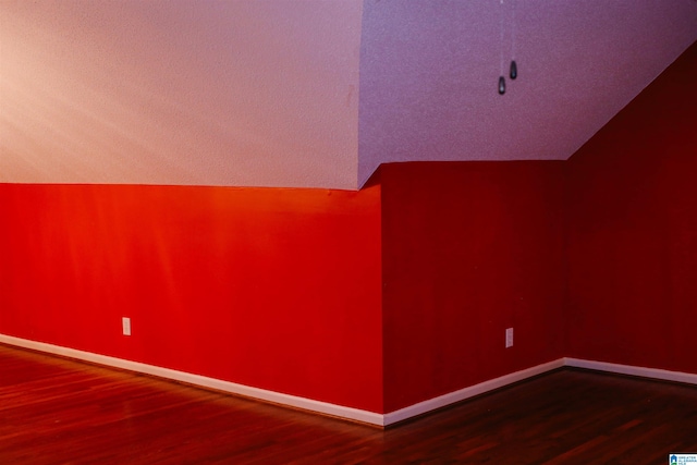 bonus room with lofted ceiling and hardwood / wood-style floors