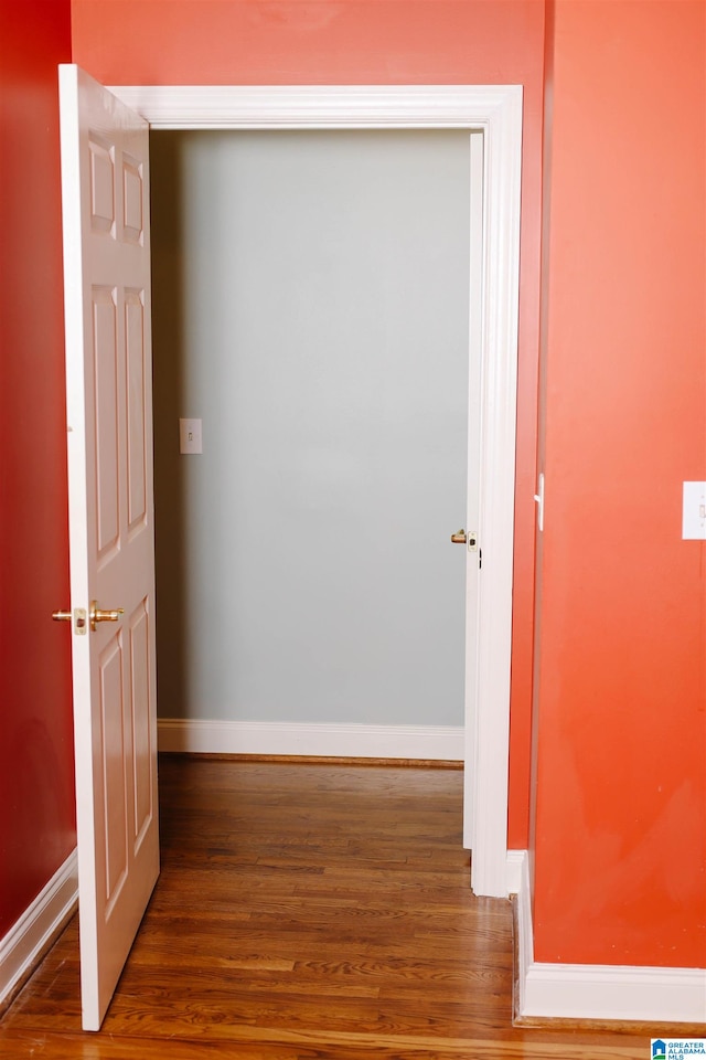 hall with hardwood / wood-style floors