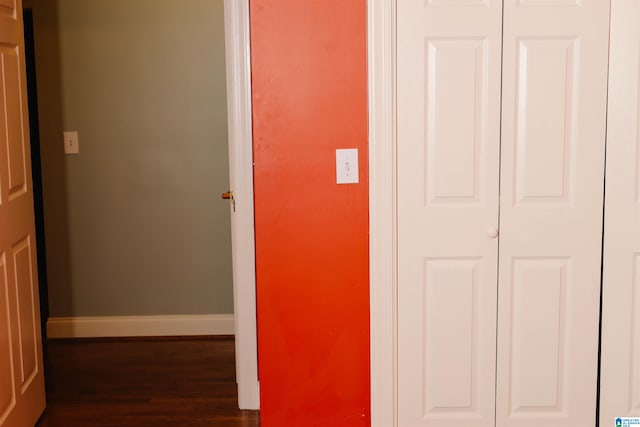 hallway with dark hardwood / wood-style flooring