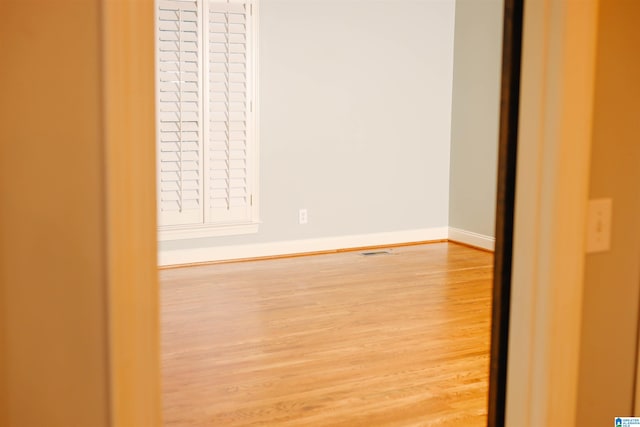 unfurnished bedroom with hardwood / wood-style floors