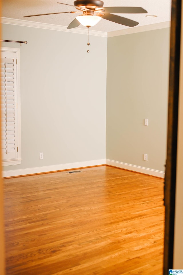 spare room with crown molding, a textured ceiling, ceiling fan, and light wood-type flooring